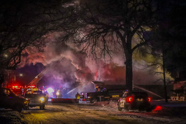 Fire at night with 6 vehicles putting out fire 